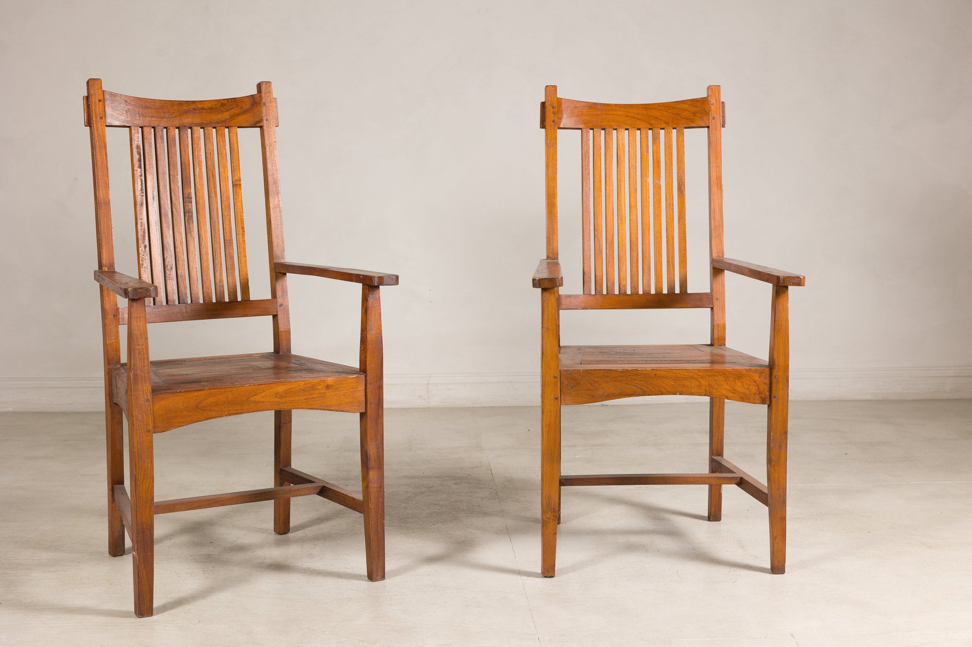 Pair of teak dining armchairs, straight-on front view