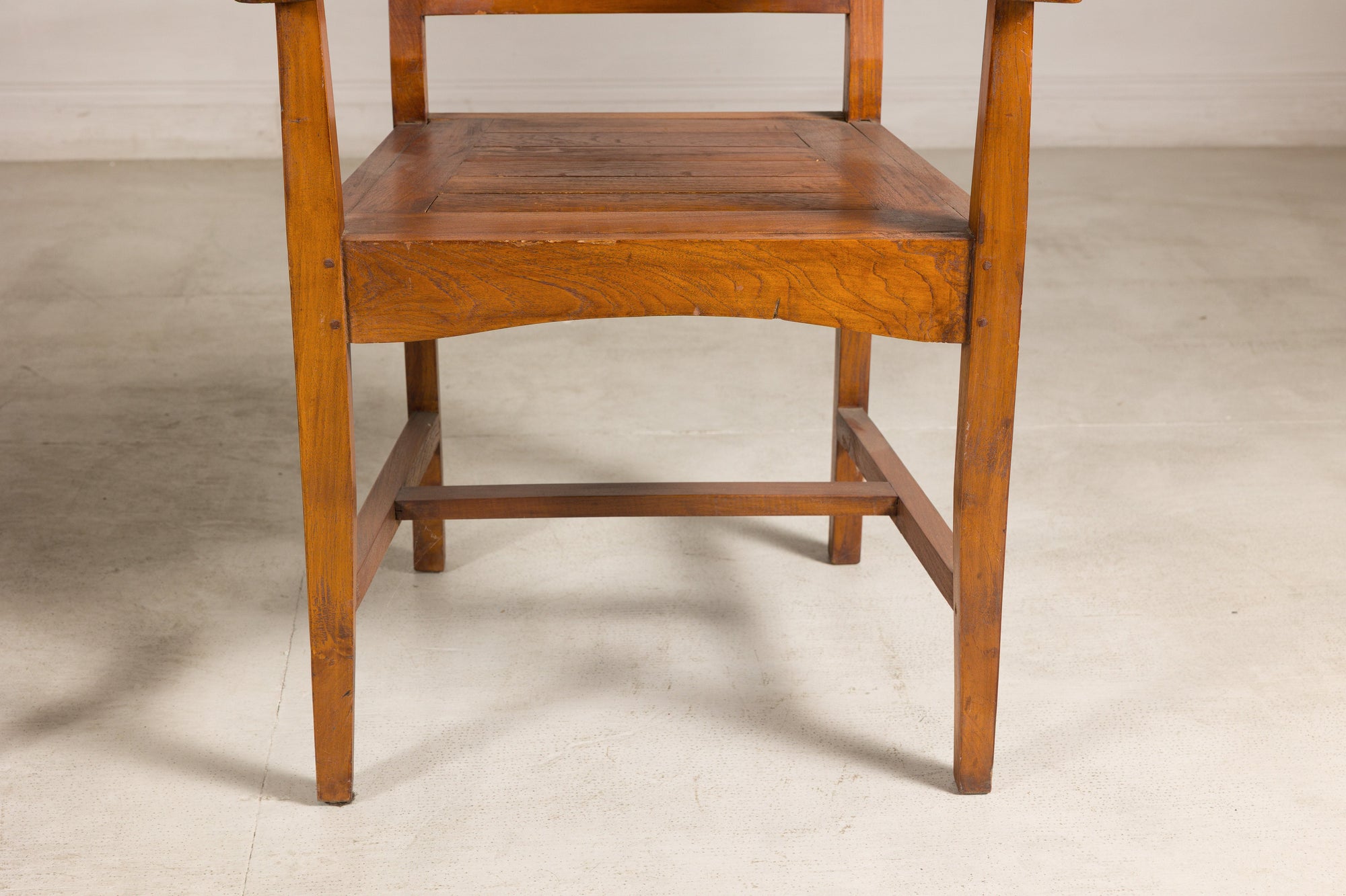 Close-up of teak armchair seat and turned front legs