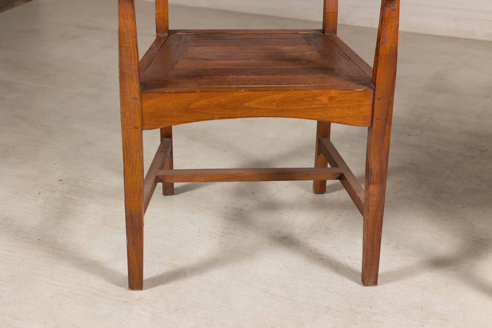 Close-up of teak armchair underside and front stretcher