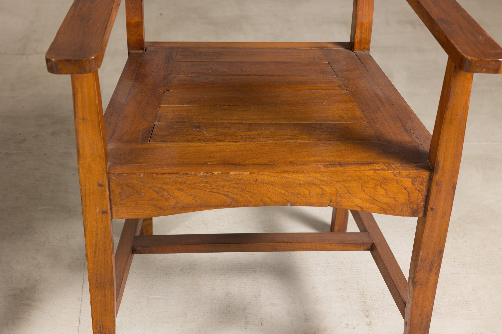Close-up of solid teak armchair seat