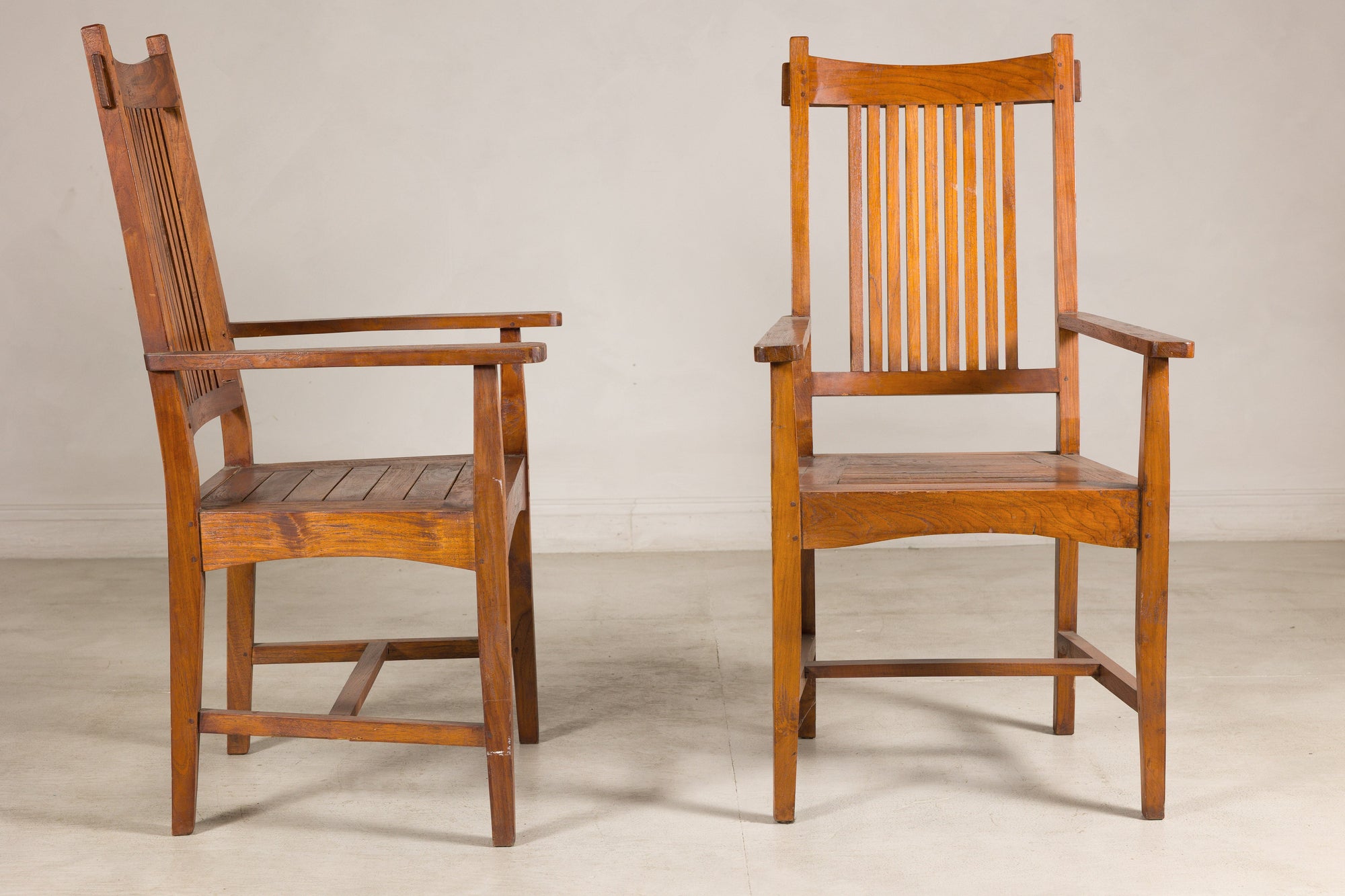 Pair of teak armchairs shown from side and front