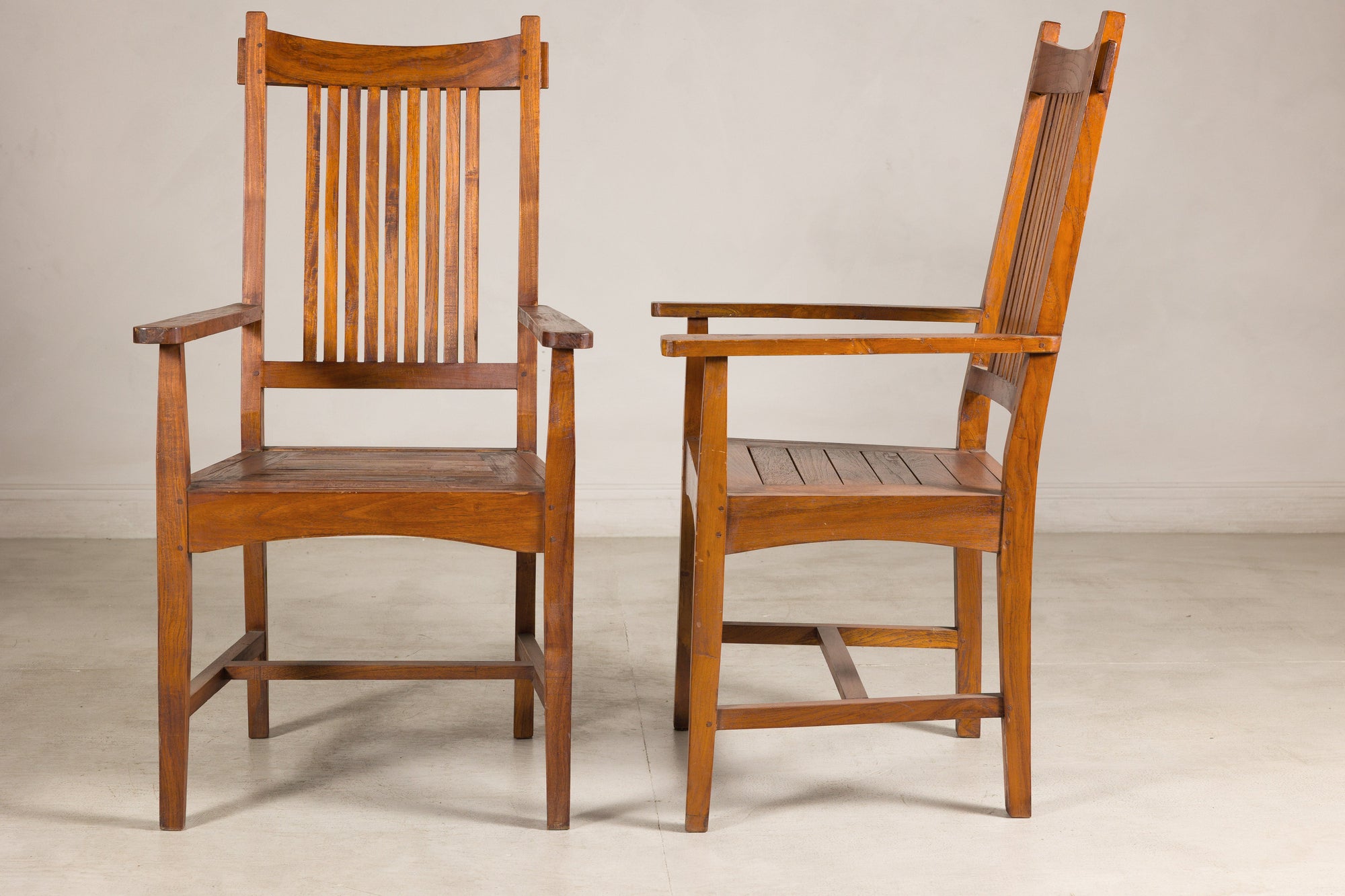 Pair of teak dining armchairs, front and side view