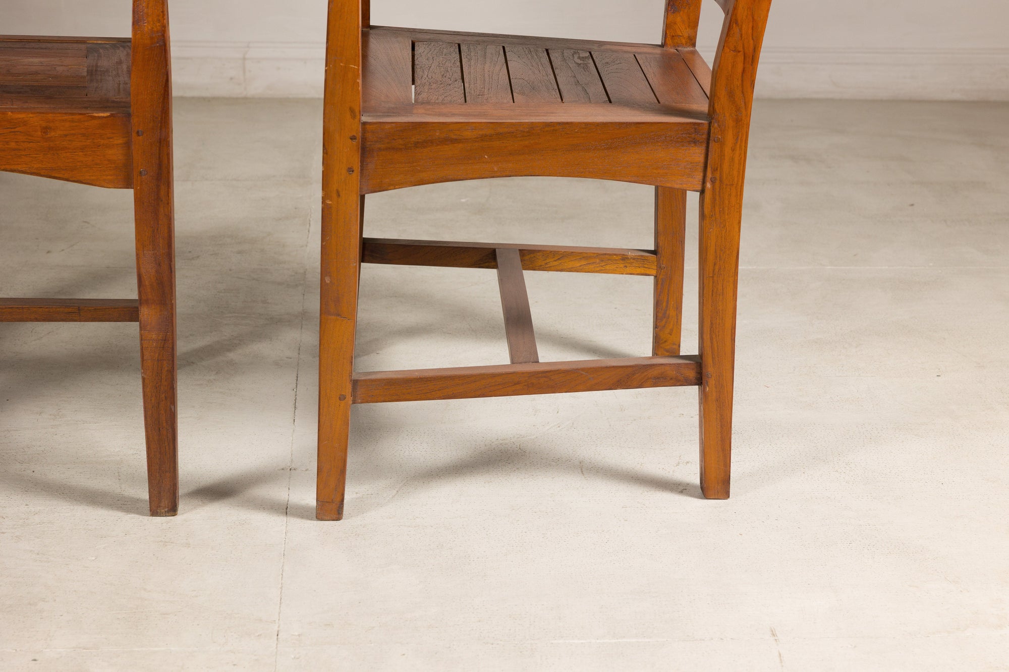 Close-up of teak chair lower legs and stretchers