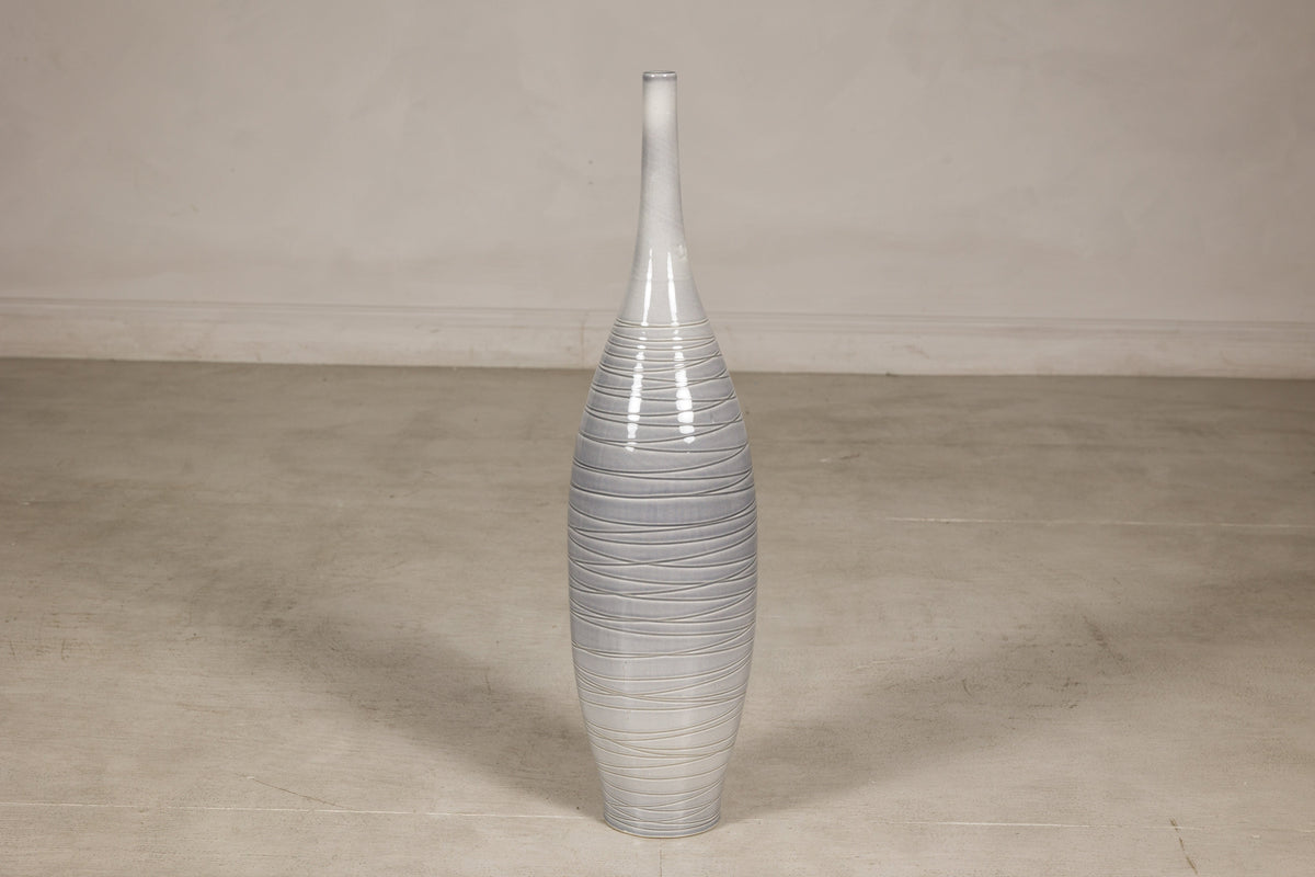 Gray ceramic bottle vase with horizontal spiral incising and modern glaze.