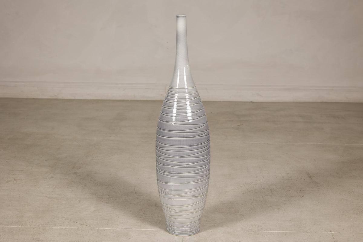 Gray glazed ceramic bottle vase with horizontal spiral incising.