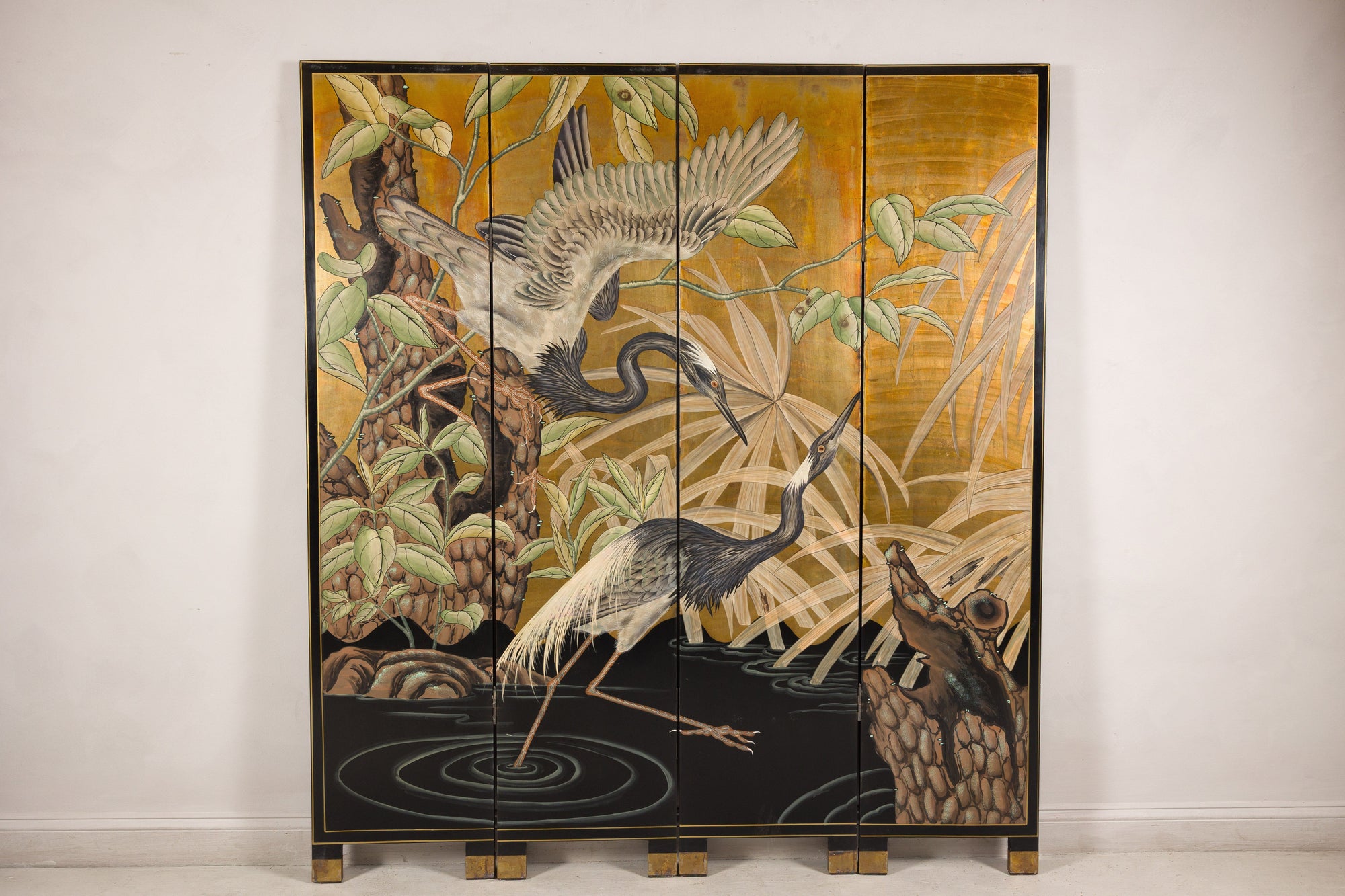 Painted crane screen displayed in an interior