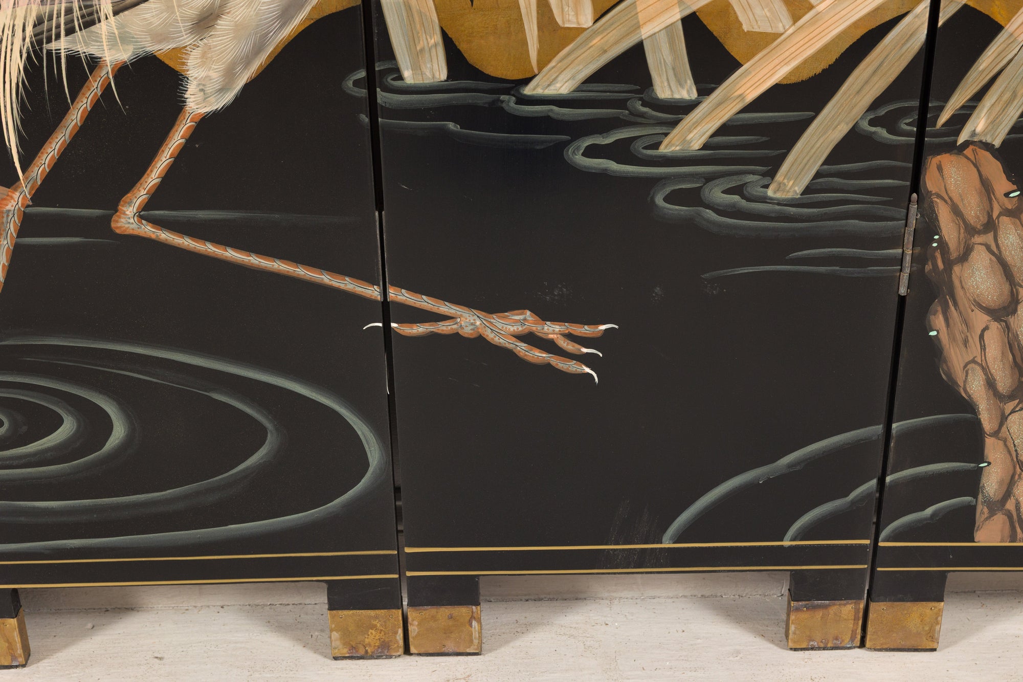 Close-up of crane legs, water and screen feet