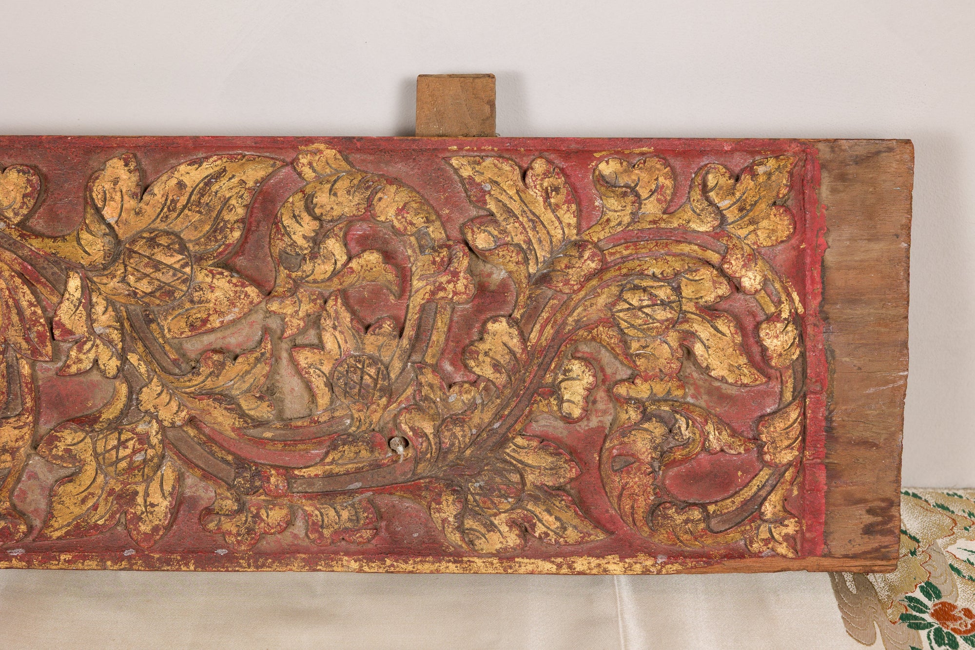 Gilt and red carved wood architectural panel base view