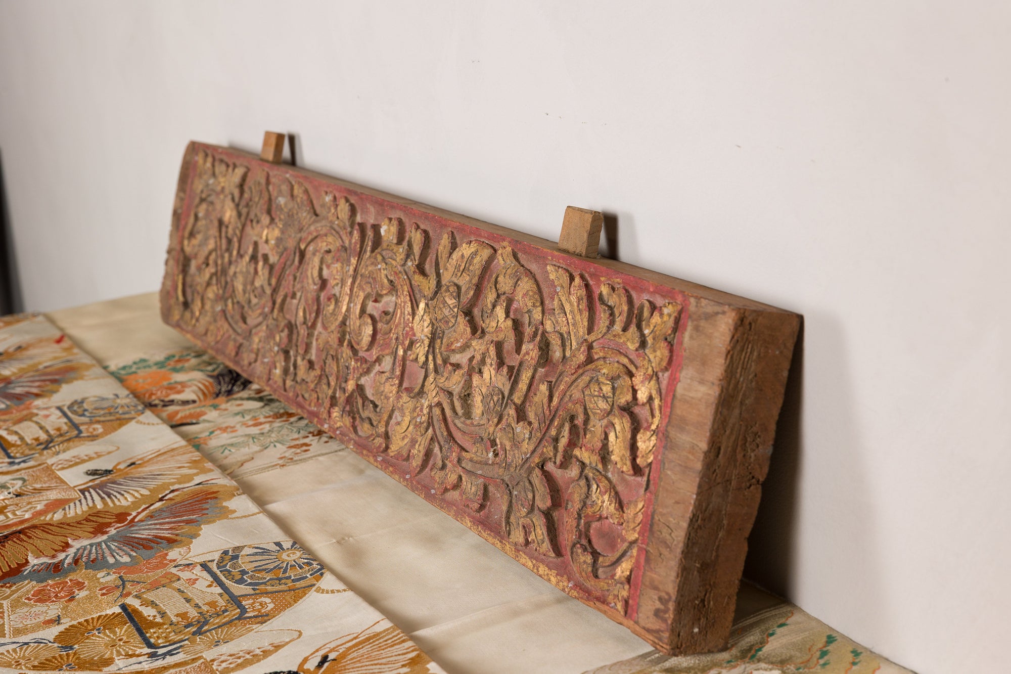 Gilt and red carved wood architectural panel surface detail
