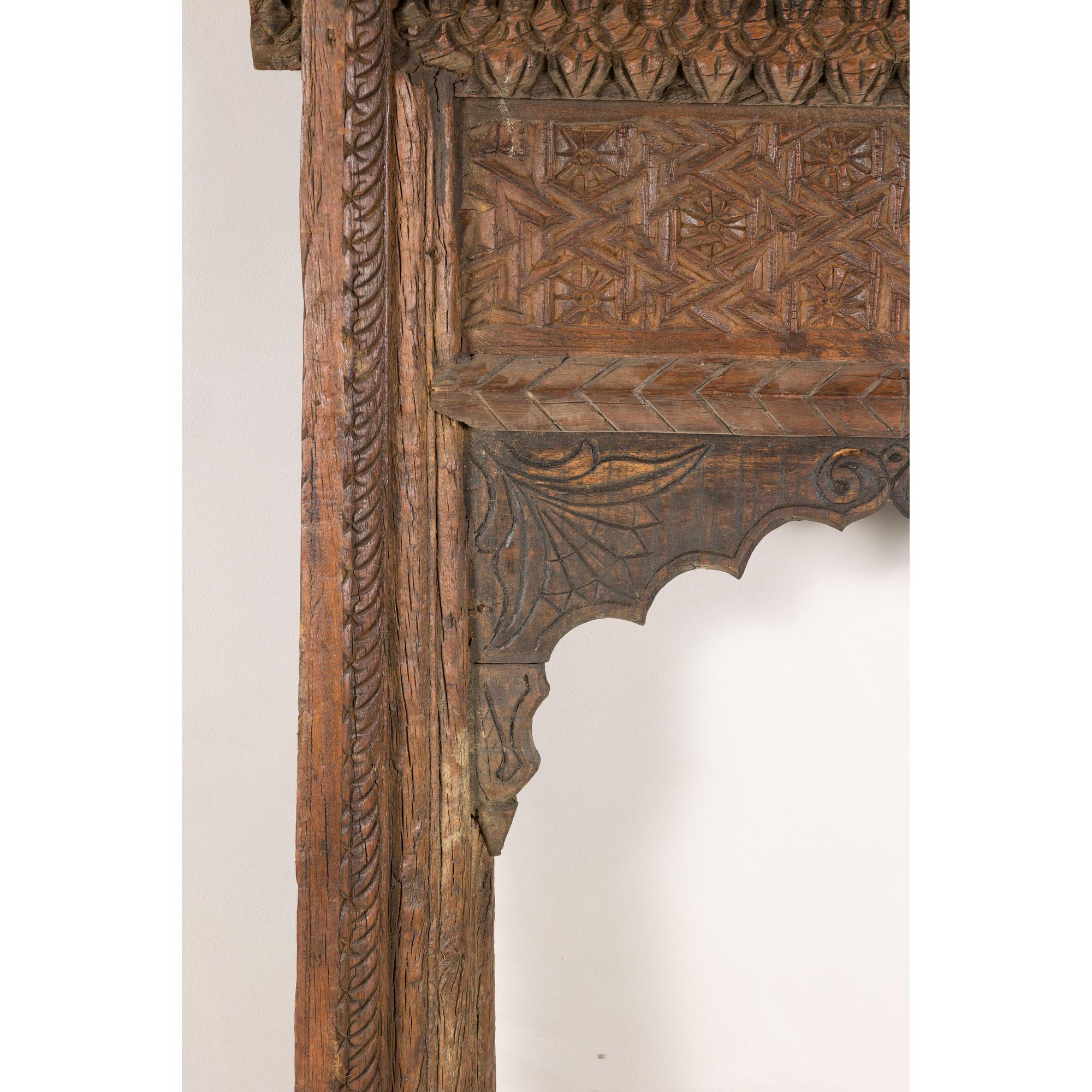 Close-up of carved arch and geometric border