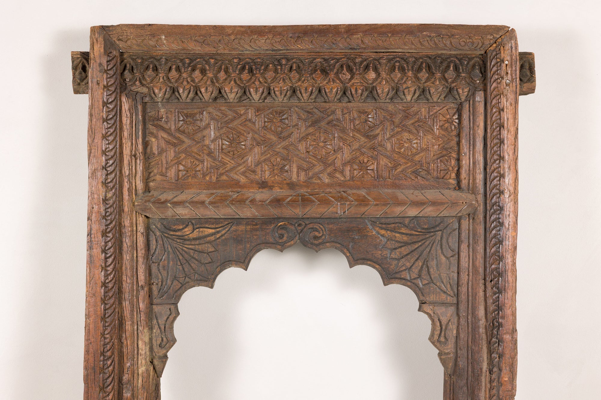 Close-up of upper carved panel and floral motifs