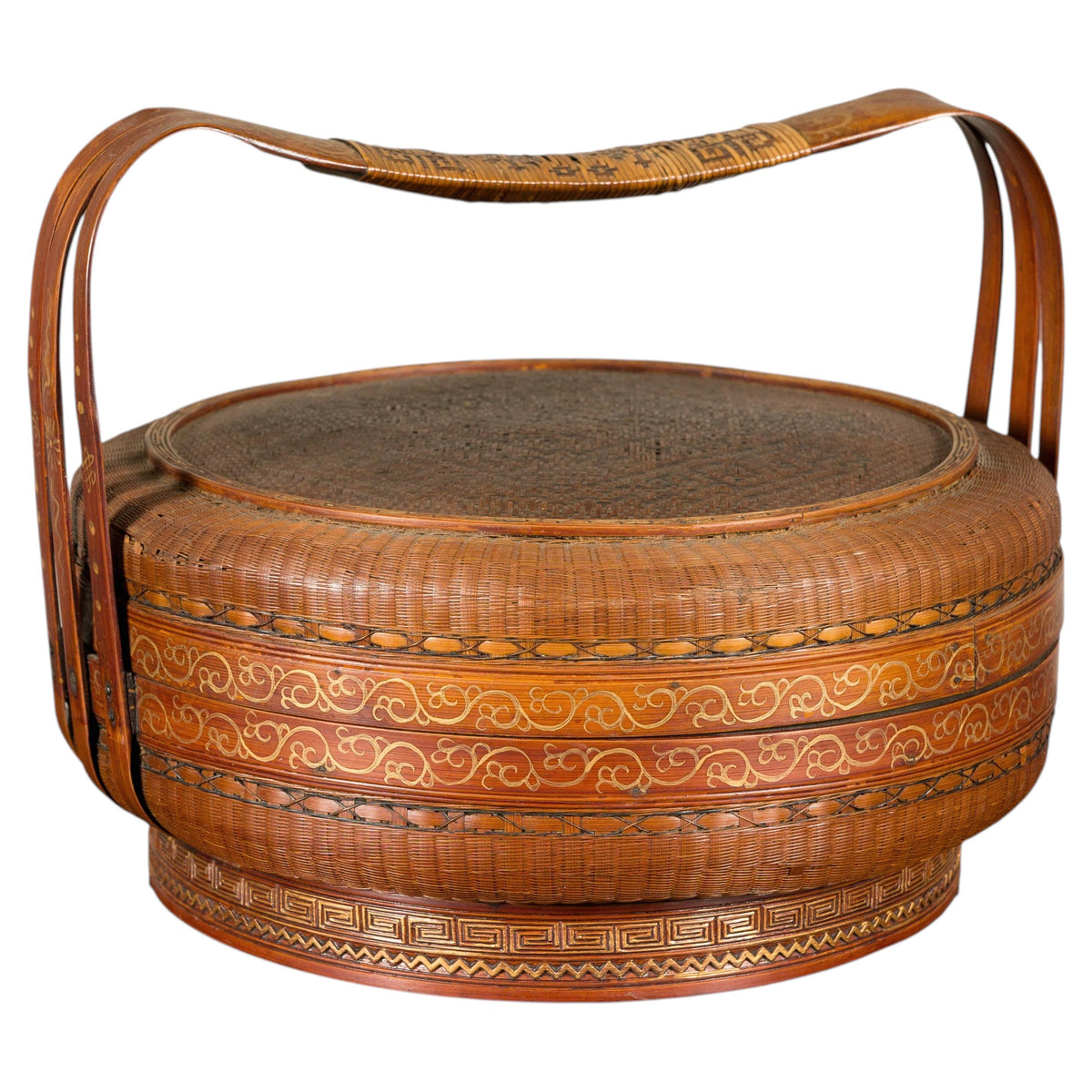 Gold and brown woven rattan Chinese basket with painted lid and curved handles.
