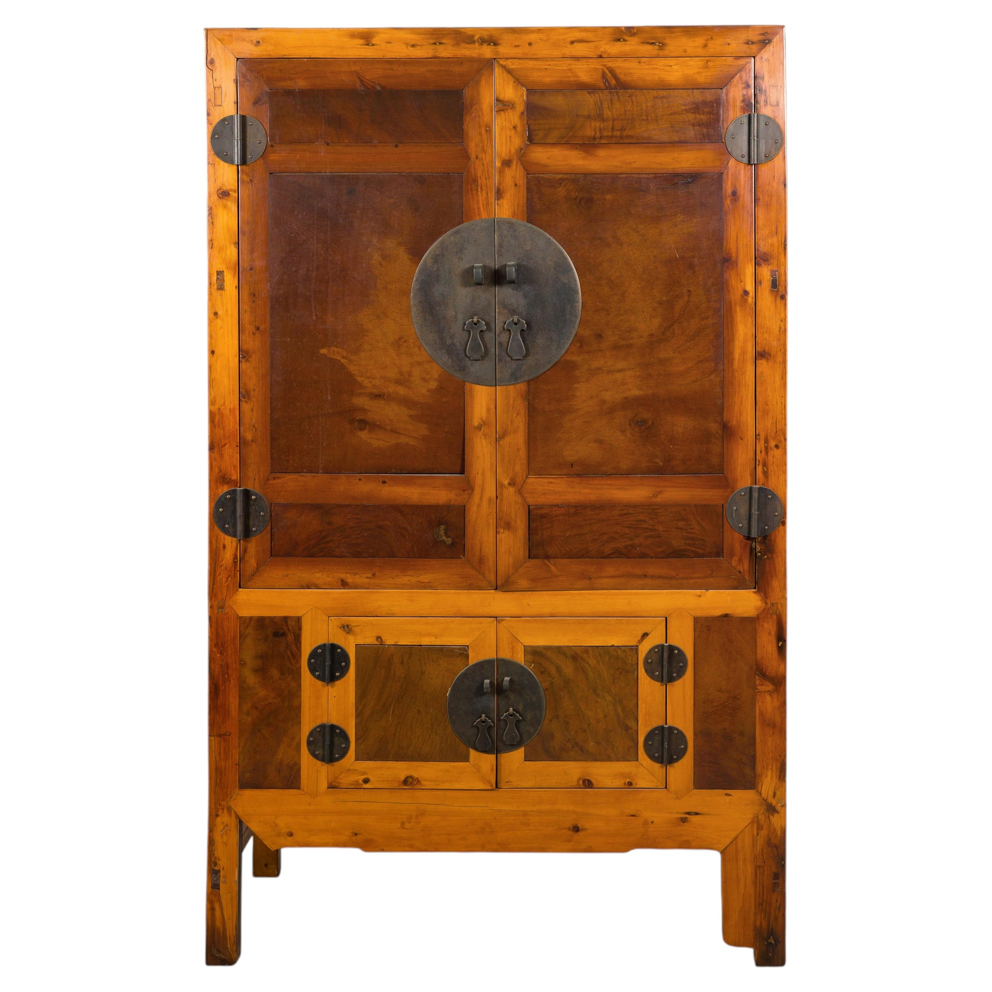 Brown Chinese elm and burl wood cabinet with brass hardware, round handles, and decorative door accents.