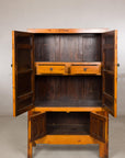 Brown Chinese elm and burl wood cabinet with brass hardware, doors open to show two drawers and shelves inside.