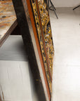 Giltwood Antique Chinese Qing wall panel with figural court scene leaning on a white bench over a light floor.