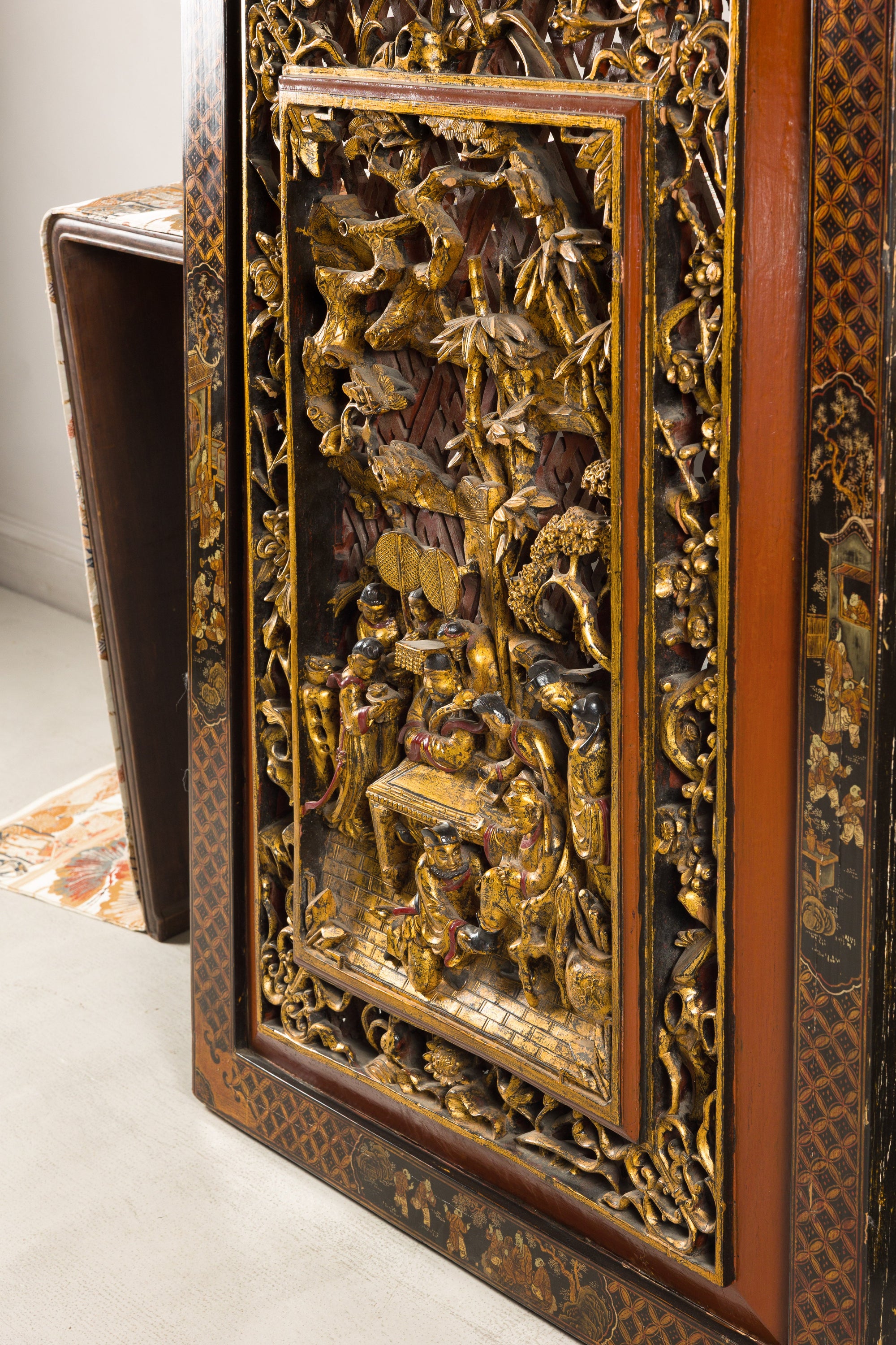 Side view of carved giltwood panel showing deep relief