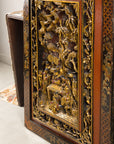 Side view of carved giltwood panel showing deep relief