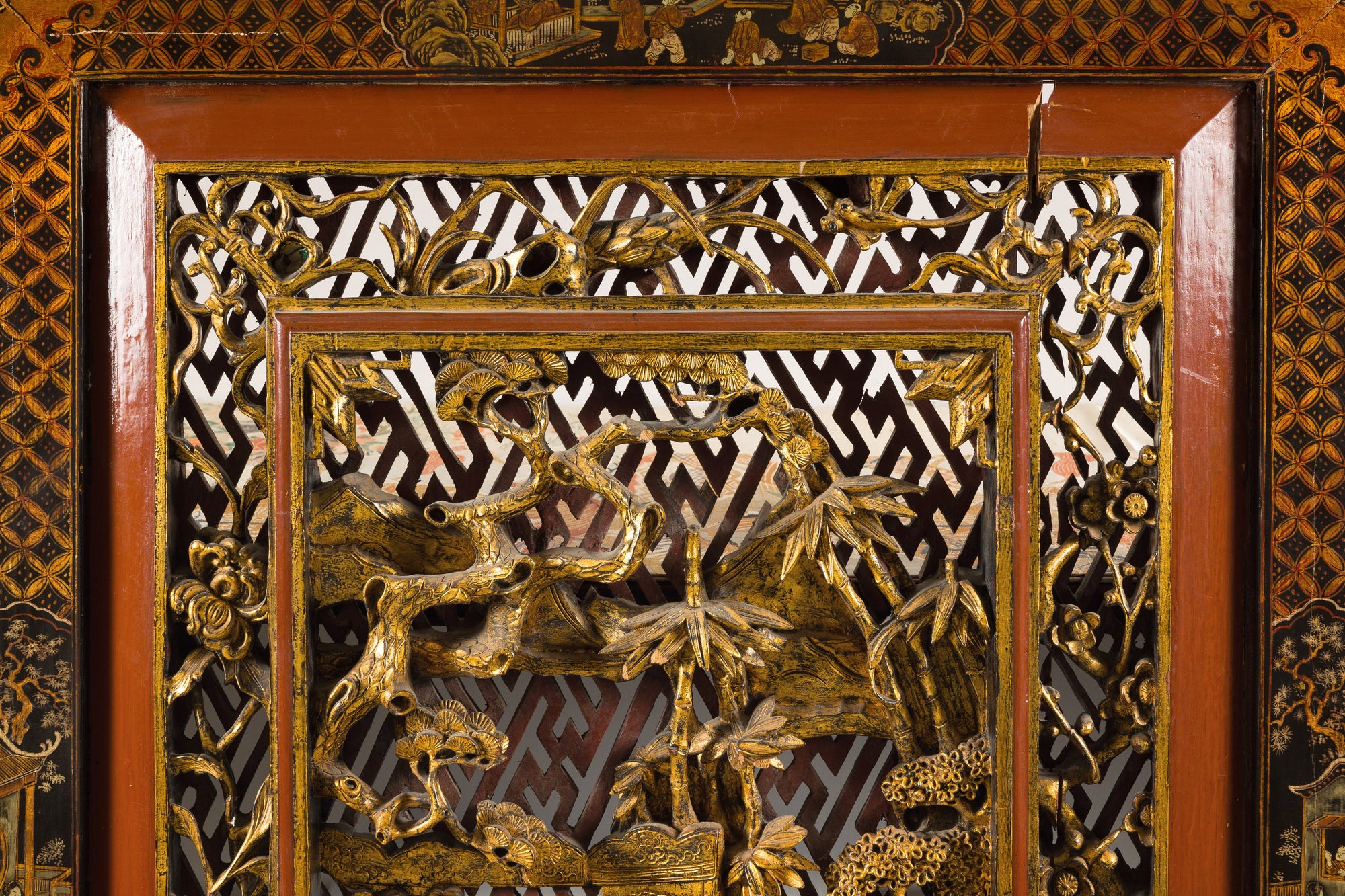 Close-up of carved figures in the upper panel