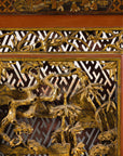 Close-up of carved figures in the upper panel