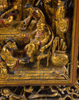 Close-up of seated dignitary and attendants in carved giltwood