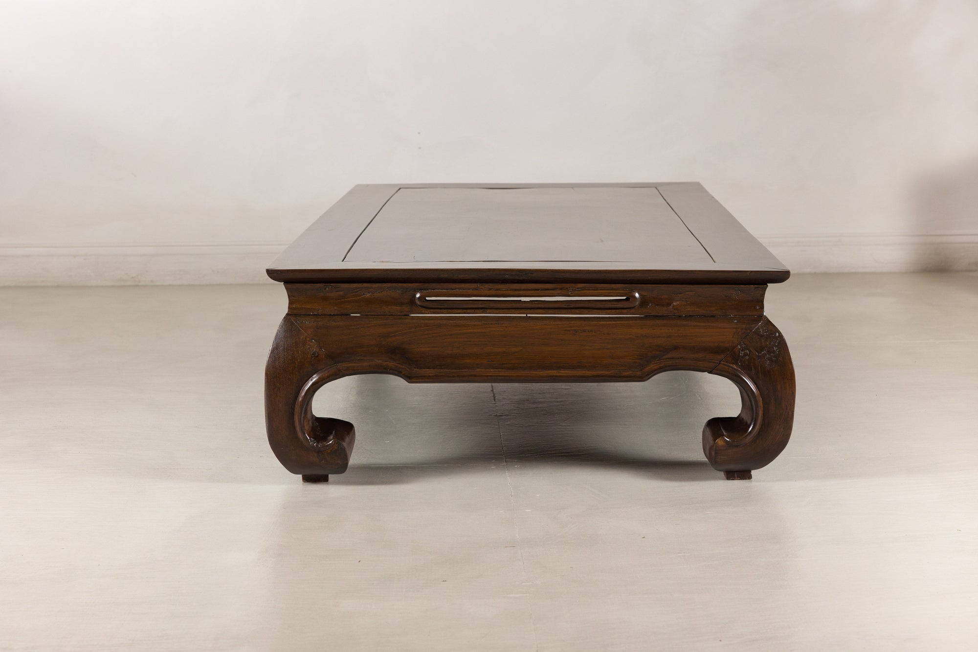 End view of the low Chinese coffee table and paired scroll feet