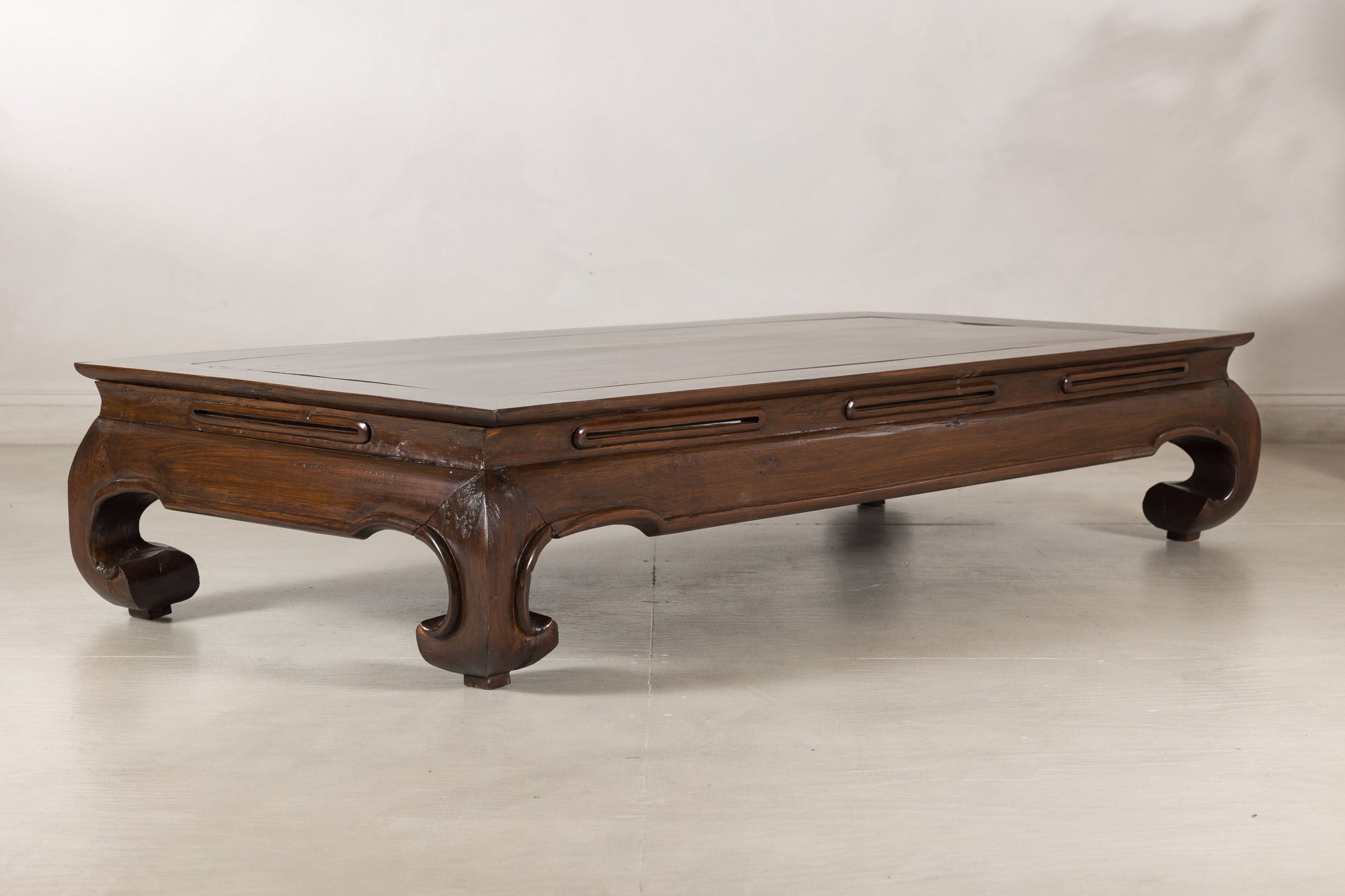 Left angled view of the elm coffee table and scroll feet