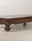 Left angled view of the elm coffee table and scroll feet