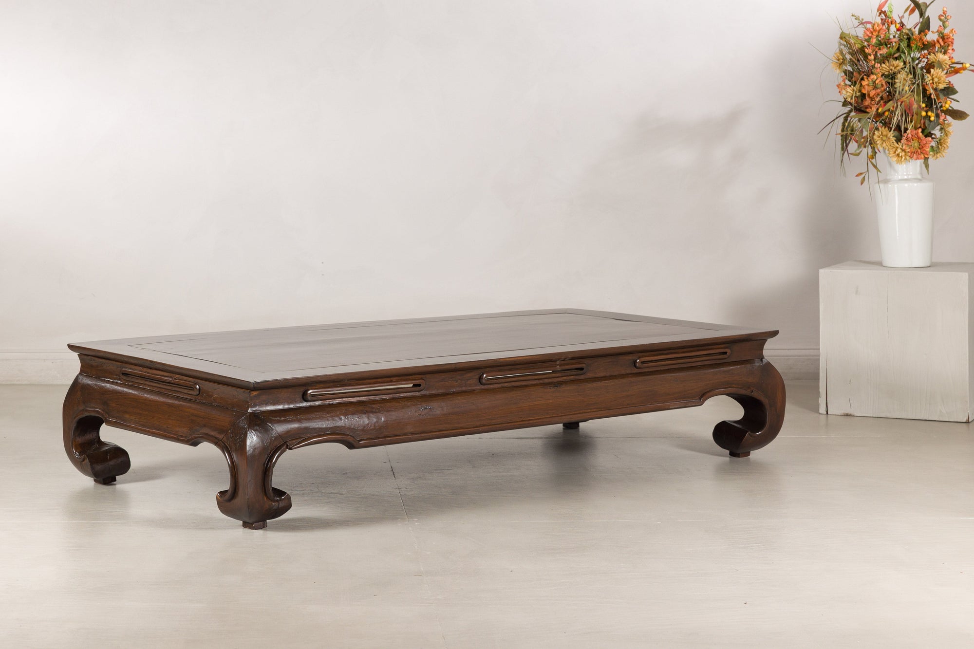 Low Chinese kang table displayed at an angle with flowers