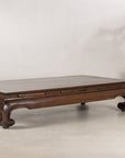 Low Chinese kang table displayed at an angle with flowers
