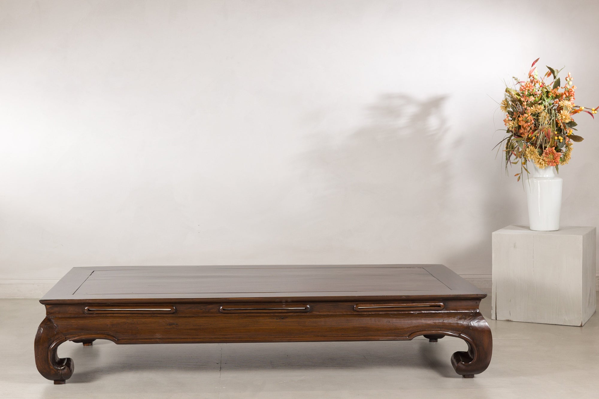 Low elm kang table displayed in a neutral room setting