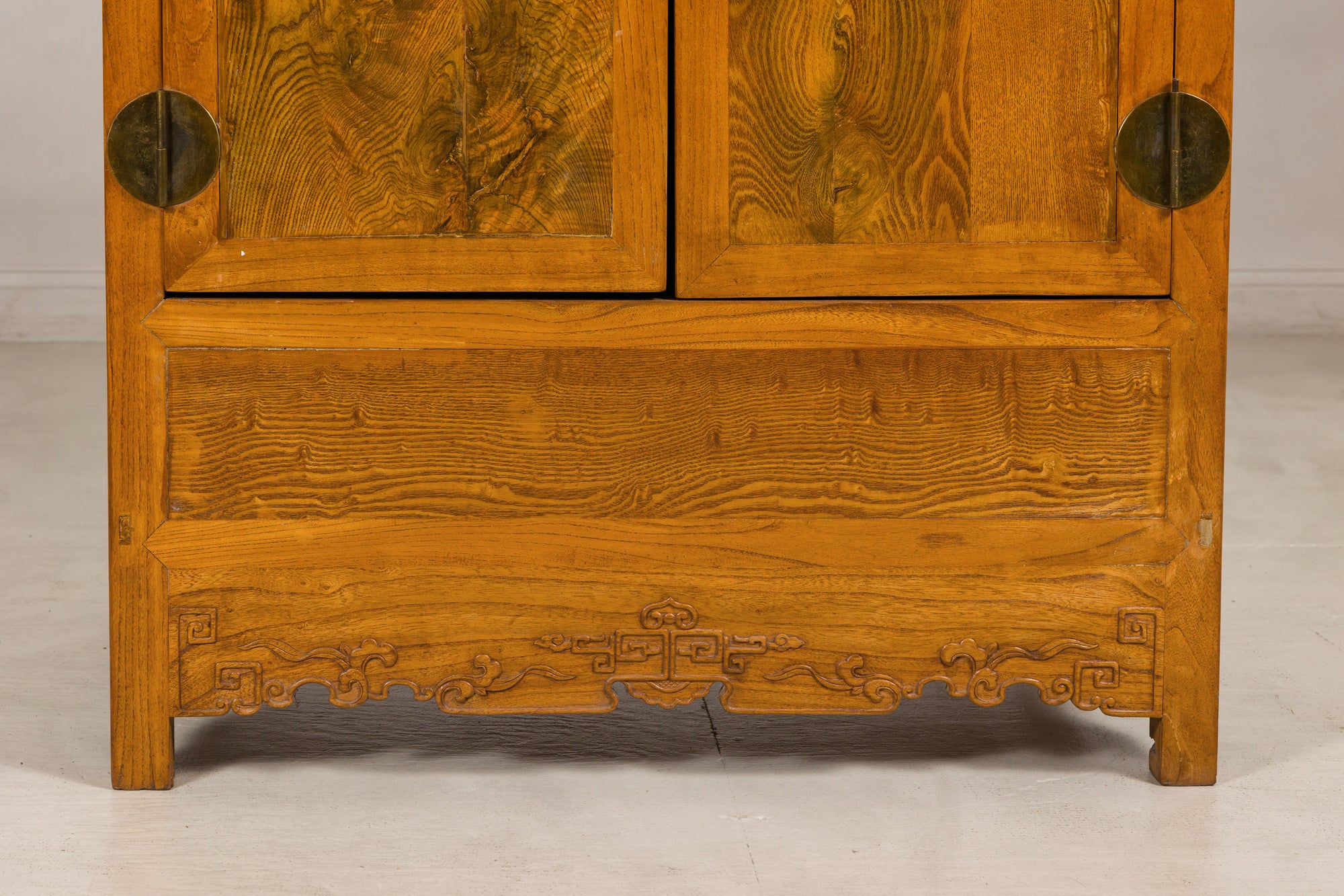 Close-up of the carved lower apron and elm wood grain