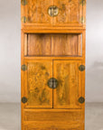 Front view of the tall Chinese cabinet with burlwood panels
