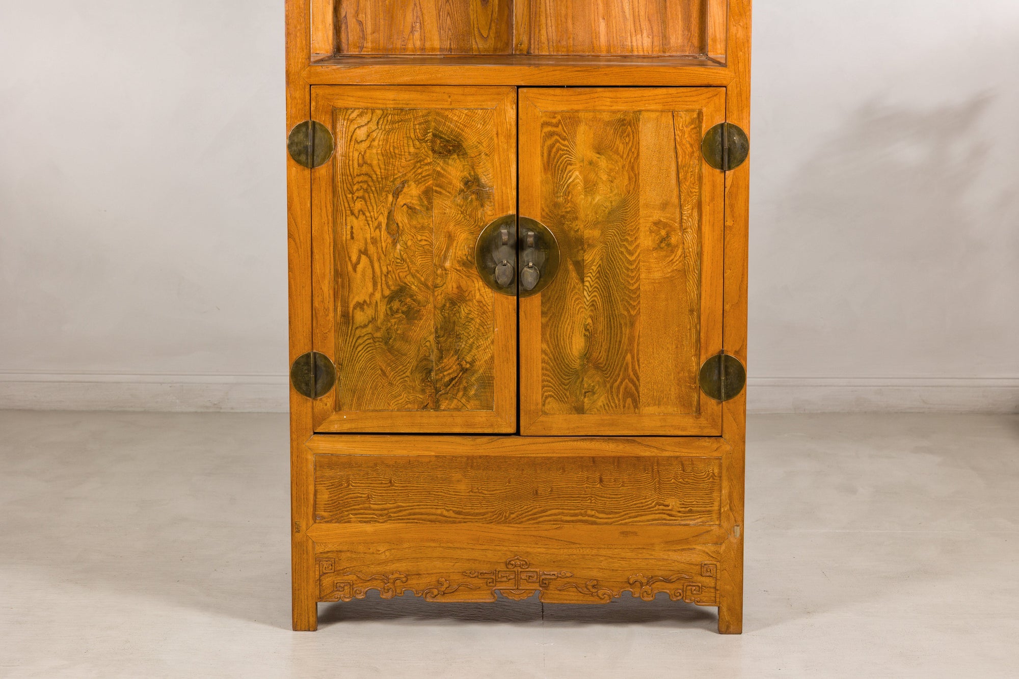Lower cabinet detail with burlwood doors and brass fittings