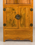 Lower cabinet detail with burlwood doors and brass fittings