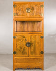 Tall Chinese elm and burlwood cabinet displayed with flowers