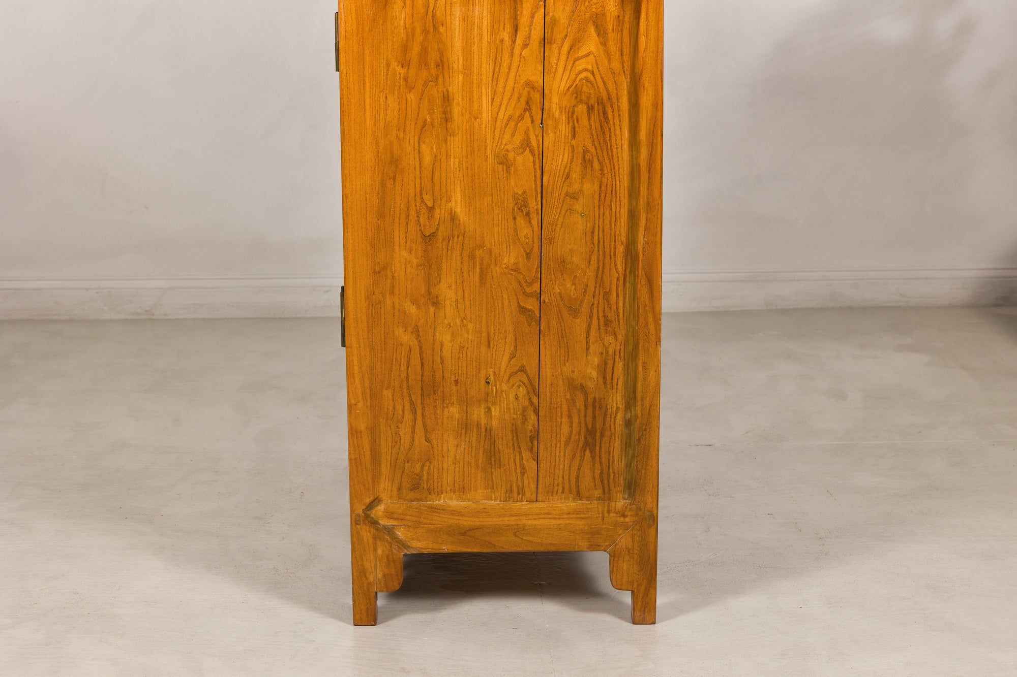 Close-up of a plain elm side panel and lower feet