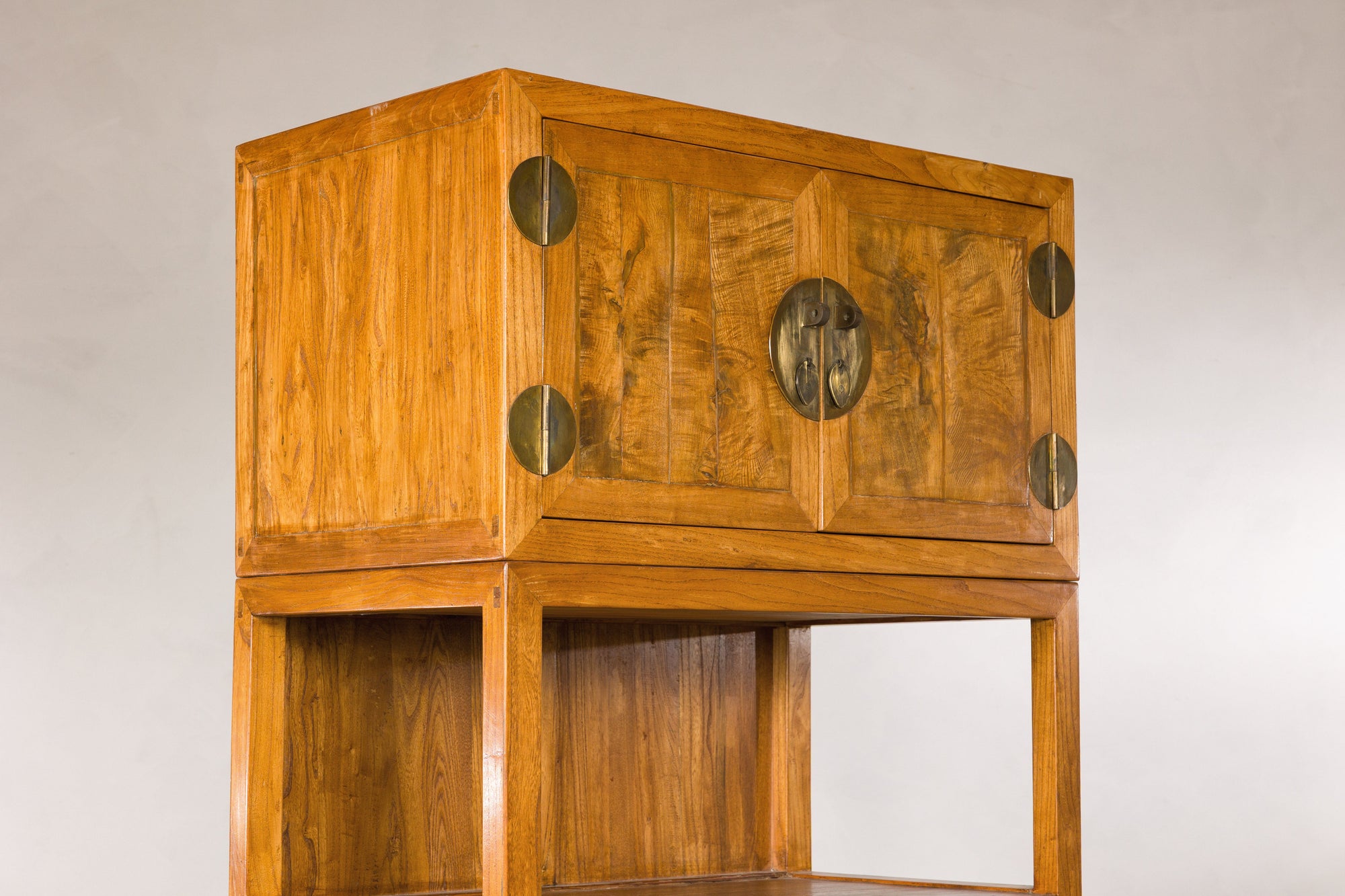 Upper left angled view of burlwood doors and open shelf