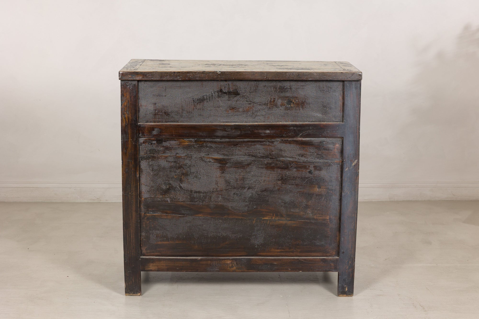 Back view of the compact Chinese cabinet in dark unfinished wood