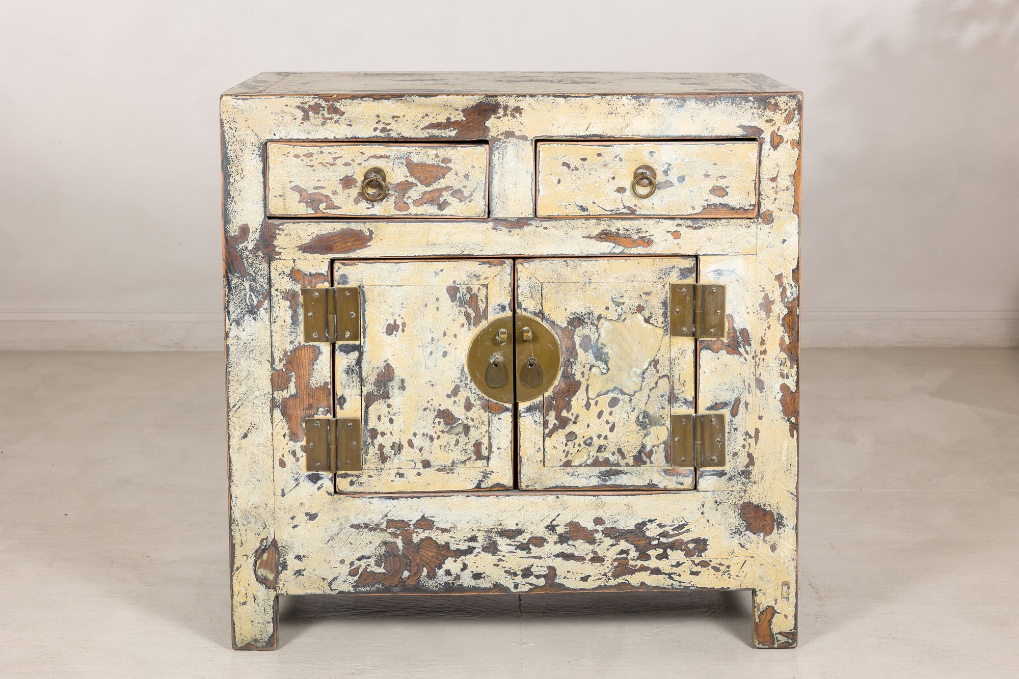 Close front view of the cabinet drawers, doors and brass hardware