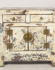 Close front view of the cabinet drawers, doors and brass hardware