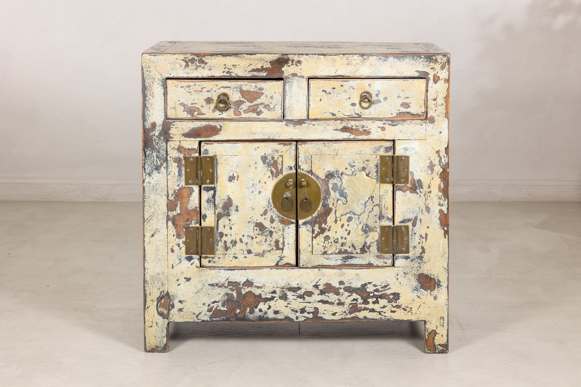 Front view of the compact cream lacquer Chinese side cabinet