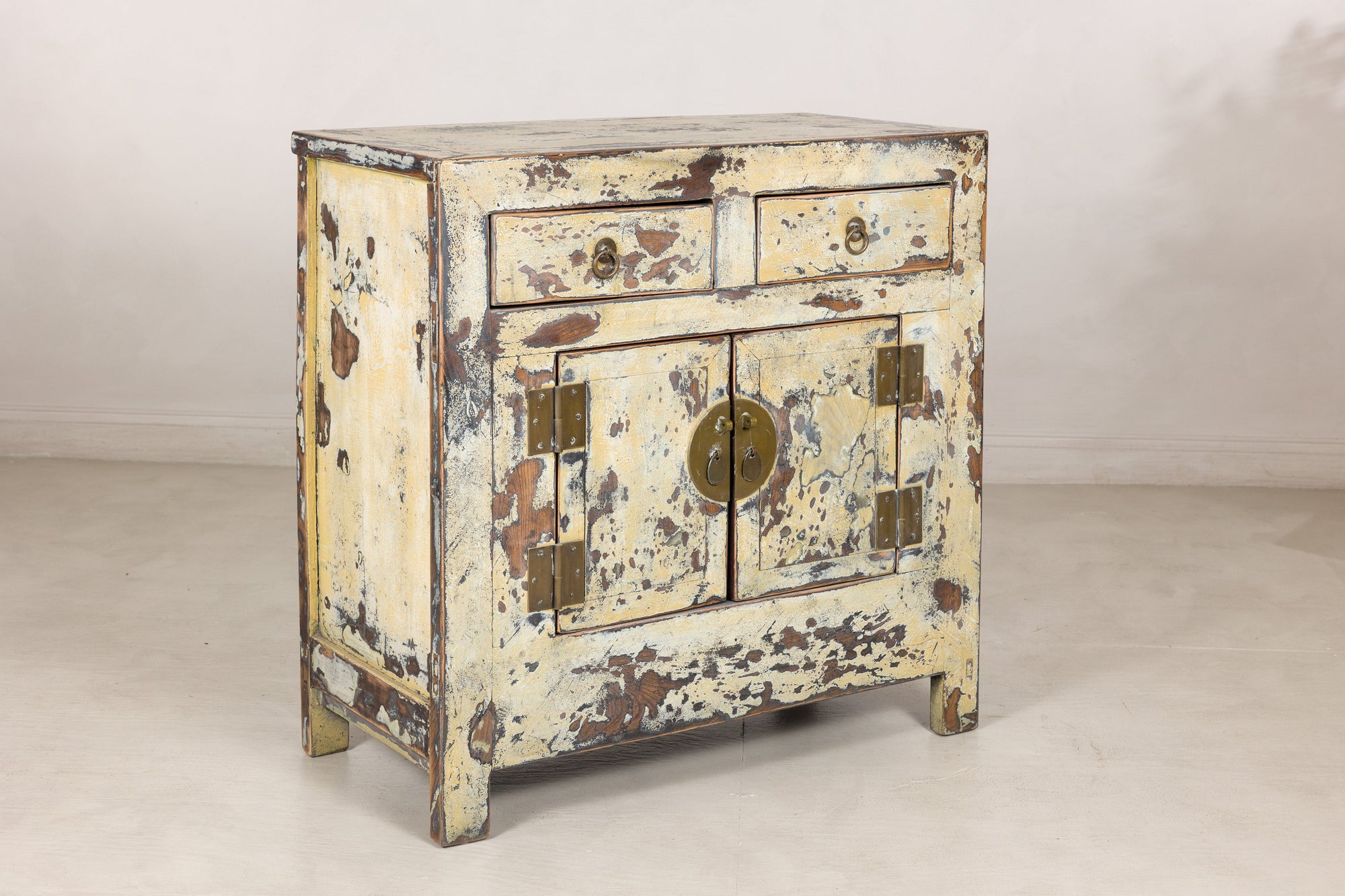 Left angled view of the distressed cream side cabinet