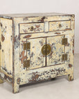 Left angled view of the distressed cream side cabinet