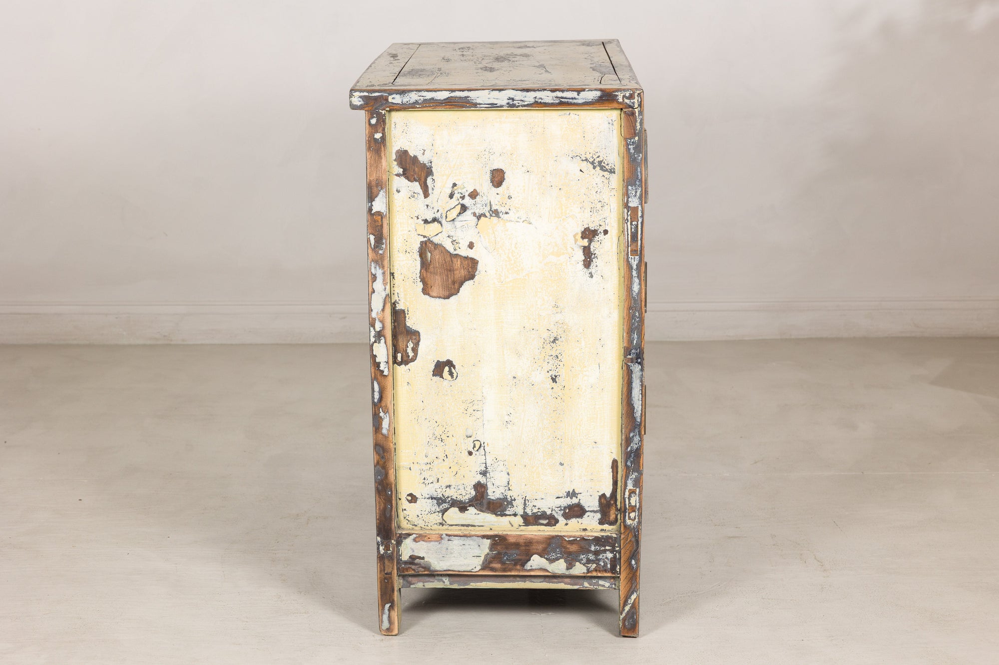 Left side view showing worn cream lacquer and exposed wood