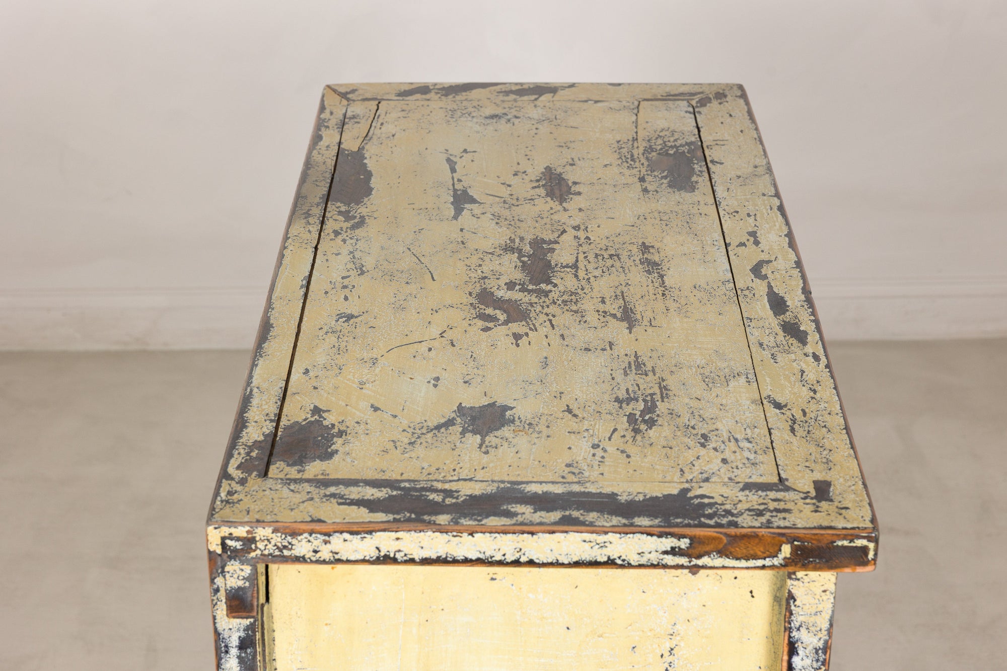 Top view showing the heavily distressed cream lacquer surface