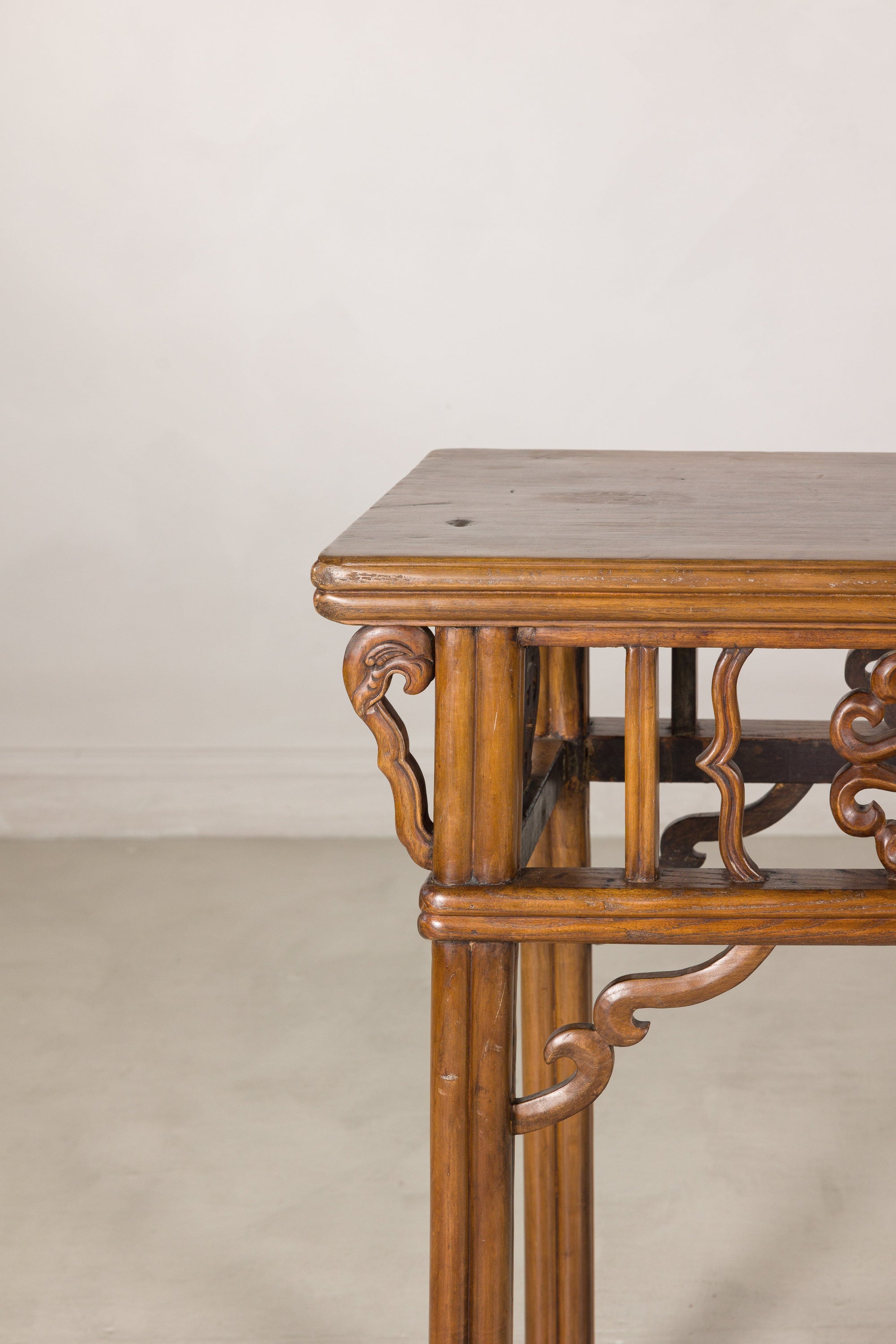 Close-up of a carved corner bracket and rounded tabletop edge