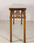 End profile showing the narrow top and carved apron motif