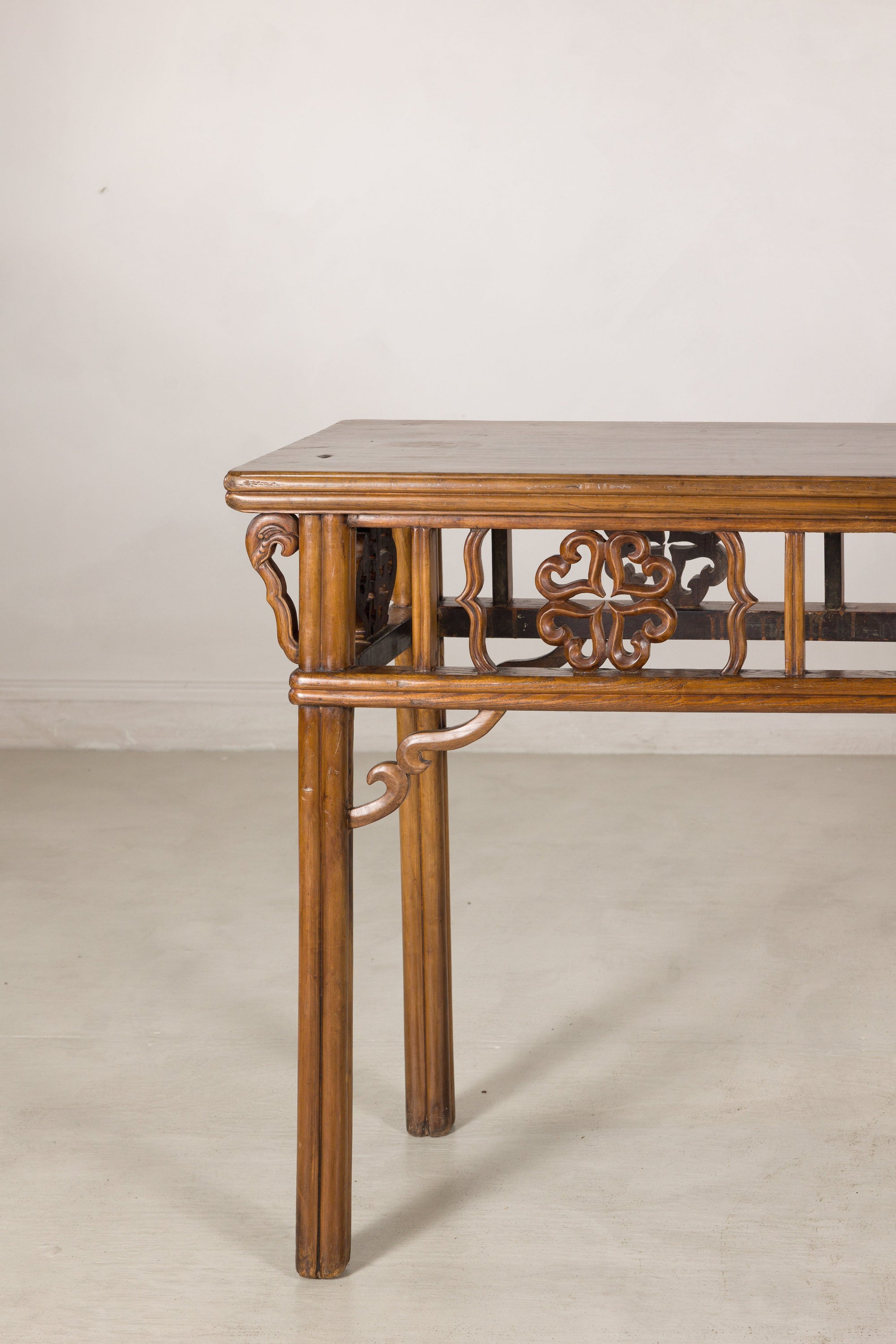Left end view of the narrow console table and carved brackets