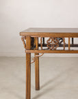 Left end view of the narrow console table and carved brackets