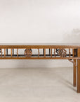 Antique Chinese console table displayed with a floral arrangement
